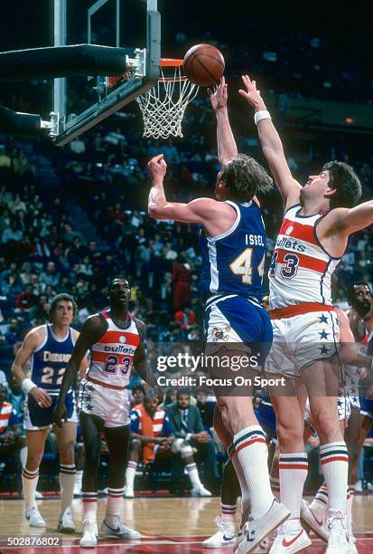 Dan Issel of the Denver Nuggets shoots over Jeff Ruland of the Washington Bullets during an NBA basketball game circa 1982 at the Capital Centre in...