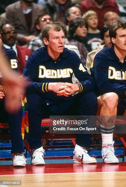 Dan Issel of the Denver Nuggets looks on from the bench against the Washington Bullets during an NBA basketball game circa 1983 at the Capital Centre...