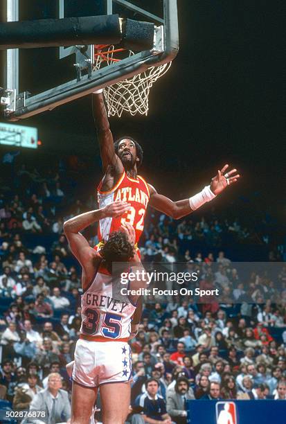 Dan Roundfield of the Atlanta Hawks shoots over Kevin Grevey of the Washington Bullets during an NBA basketball game circa 1980 at the Capital Centre...