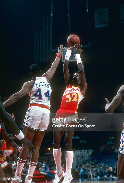 Dan Roundfield of the Atlanta Hawks shoots over Rick Mahorn of the Washington Bullets during an NBA basketball game circa 1982 at the Capital Centre...