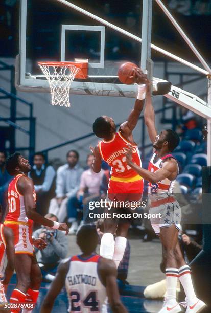 Dan Roundfield of the Atlanta Hawks goes up to grab a rebound away from Don Collins of the Washington Bullets during an NBA basketball game circa...