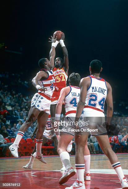 Dan Roundfield of the Atlanta Hawks shoots over Rick Mahorn of the Washington Bullets during an NBA basketball game circa 1984 at the Capital Centre...