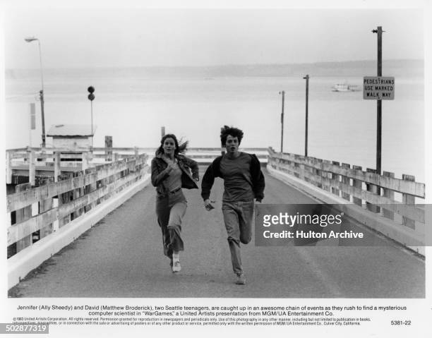 Ally Sheedy, Matthew Broderick run in a scene for the MGM/UA movie "WarGames" circa 1983.