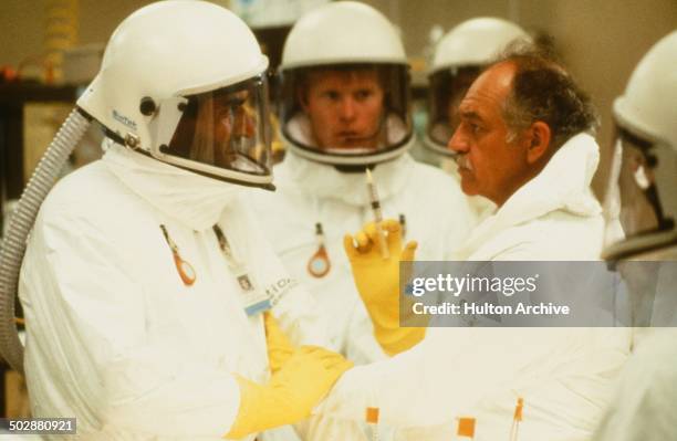 Sam Waterston stops an injection from Richard Dysart in a gene splicing lab in a scene for the 20th Century Fox movie "Warning Sign" circa 1985.