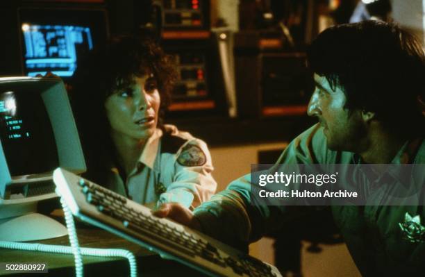 Kathleen Quinlan and Sam Waterston talk at a computer in a scene for the 20th Century Fox movie "Warning Sign" circa 1985.