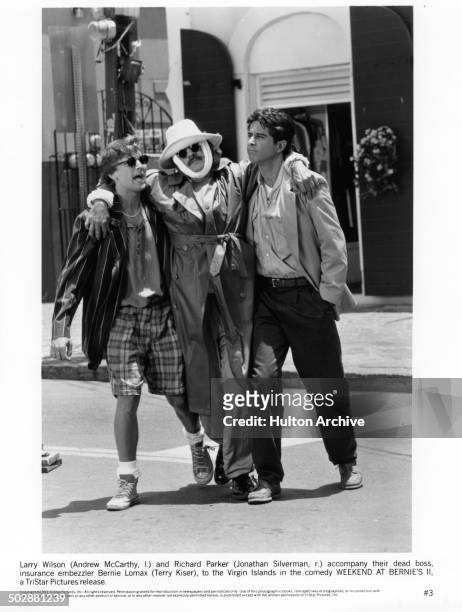 Andrew McCarthy with Jonathan Silverman carry their dead boss Terry Kiser in a scene from the TriStar Pictures movie "Weekend at Bernie's II" circa...