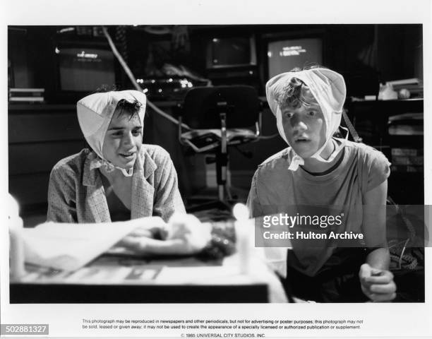Actors Ilan Mitchell-Smith and Anthony Michael Hall wear bras on their heads in a scene of the Universal Studio movie "Weird Science"