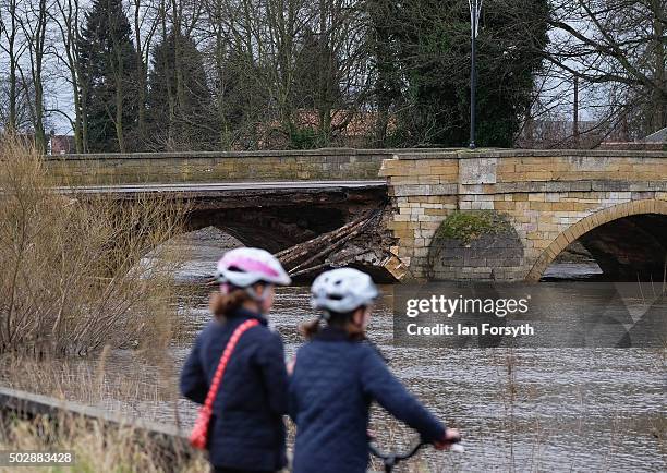 Two children stand and look at the bridge over the River Wharfe which collapsed due to heavy flooding on December 30, 2015 in Tadcaster, England....