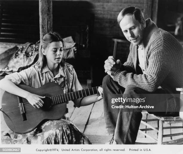 Jan Smithers signs with her father Rance Howard in a scene for the United Artist movie "Where the Lilies Bloom" circa 1974.