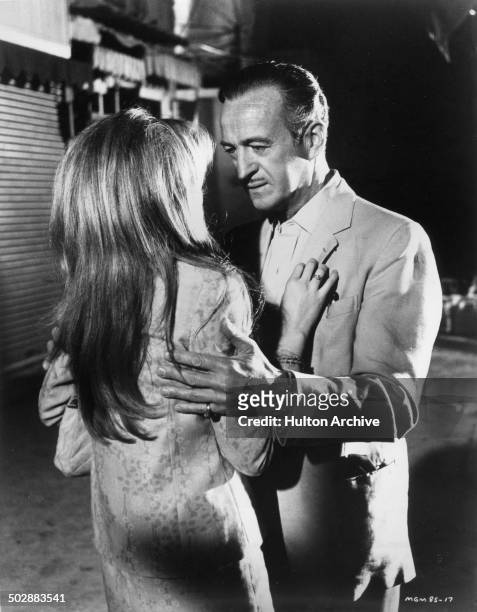 David Niven grabs Francoise Dorleac in a scene from the MGM movie "Where the Spies Are" circa 1965.
