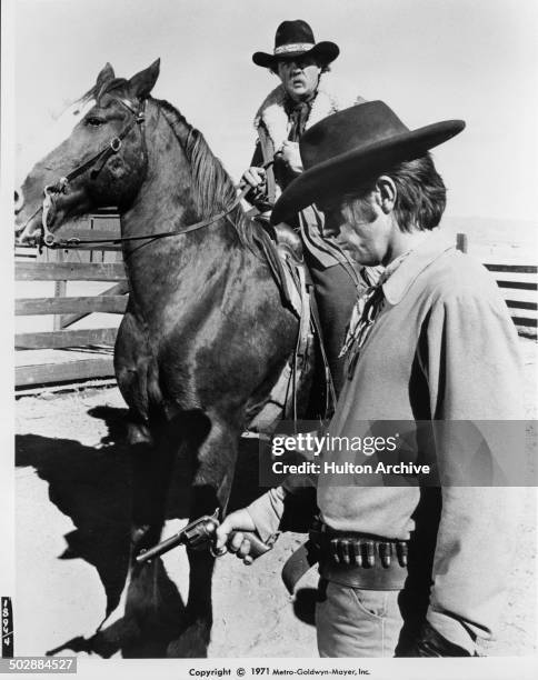 Tom Skerritt looks forlorn as Karl Malden rides up, in a scene for the the MGM movie "Wild Rovers" circa 1971.