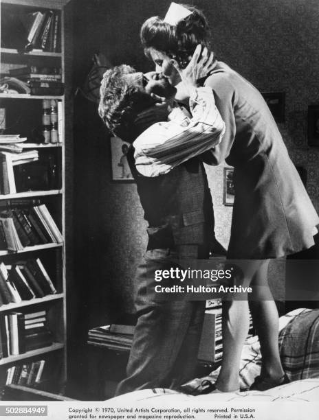 George Segal kisses Trish Van Devere in a scene from the United Artist movie "Where's Poppa?" circa 1970.
