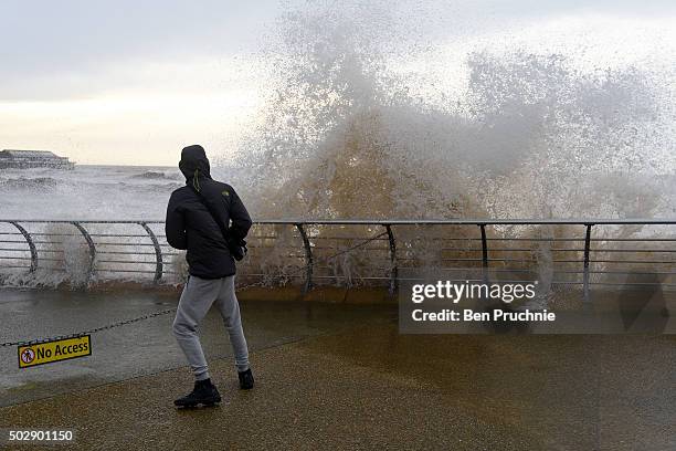 Boy dodges a wave as heavy winds produce waves on Blackpool seafront as Storm Frank hits the United Kingdom on December 30, 2015 in Blackpool,...