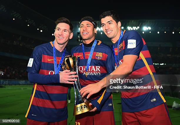 Lionel Messi, Neymar and Luis Suarez of Barcelona hold the Winner's Trophy after the FIFA Club World Cup Final match between River Plate and FC...