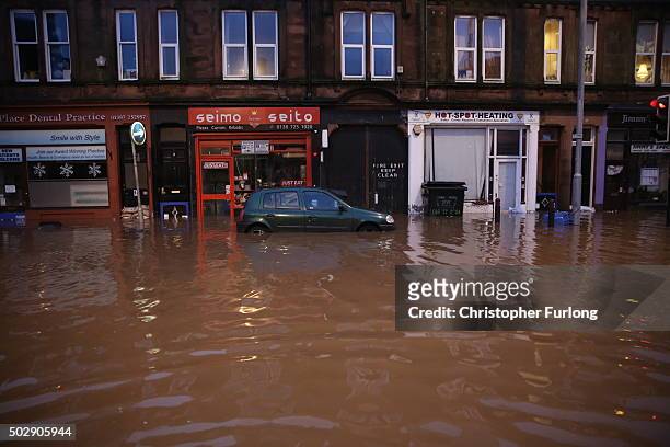 Shop fronts surrounded by water are seen as the River Nith bursts its banks on December 30, 2015 in Dumfries, Scotland. Severe flooding has affected...