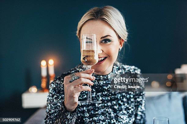 beautiful woman celebrating new year with champagne - woman in sequin dress stock pictures, royalty-free photos & images