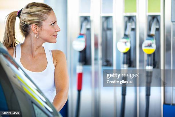 woman at gas station. - premium gasoline stock pictures, royalty-free photos & images