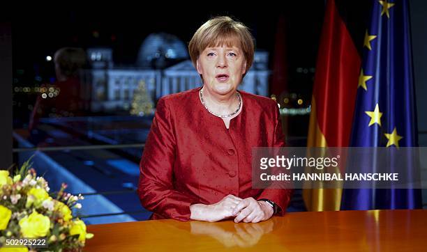 German Chancellor Angela Merkel poses after recording her New Year's speech in the Chancellery in Berlin, on December 30, 2015. / AFP / HANNIBAL...