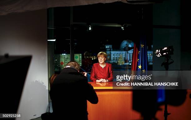 German Chancellor Angela Merkel poses after recording her New Year's speech in the Chancellery in Berlin, on December 30, 2015. / AFP / HANNIBAL...