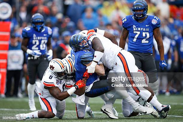 Paxton Lynch of the Memphis Tigers is sacked by Montravius Adams and Cassanova McKinzy of the Auburn Tigers in the first half of the Birmingham Bowl...