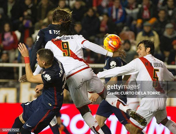 Atletico Madrid's forward Fernando Torres jumps for the ball with Rayo Vallecano's Angolan forward Alberto Manucho during the Spanish league football...
