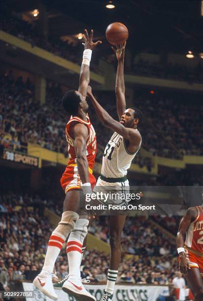 Cedric Maxwell of the Boston Celtics shoots over Dan Roundfield of the Atlanta Hawks during an NBA basketball game circa 1979 at the Boston Garden in...