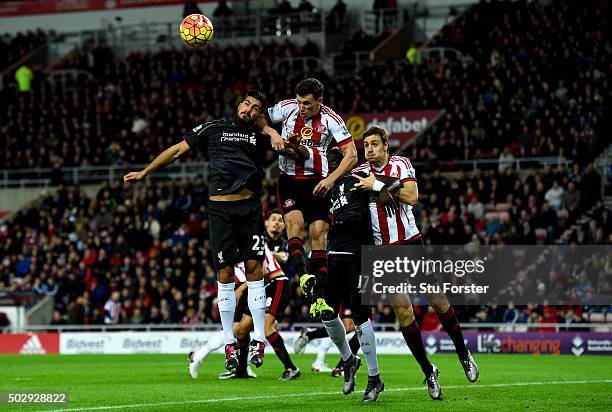 Emre Can of Liverpool and Billy Jones of Sunderland jump for the ball in front of Mamadou Sakho of Liverpool and Sebastian Coates of Sunderland...