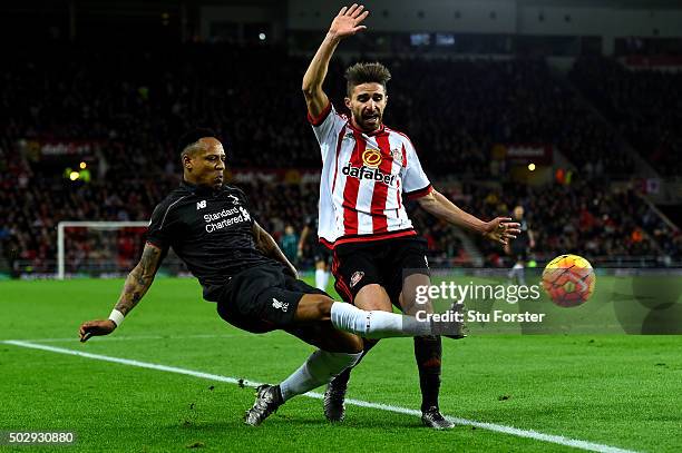 Nathaniel Clyne of Liverpool battles for the ball with Fabio Borini of Sunderland during the Barclays Premier League match between Sunderland and...