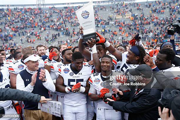 The Auburn Tigers celebrate after winning the Birmingham Bowl against the Memphis Tigers at Legion Field on December 30, 2015 in Birmingham, Alabama....