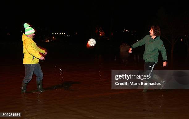 Residents of Kingsmeadows Road keep their spirits up by having a light hearted game of football in the flooded street after managing to keep flood...