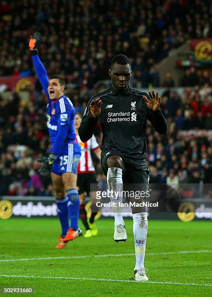 Christian Benteke of Liverpool celebrates after scoring the opening goal as Vito Mannone of Sunderland appeals for offside during the Barclays...