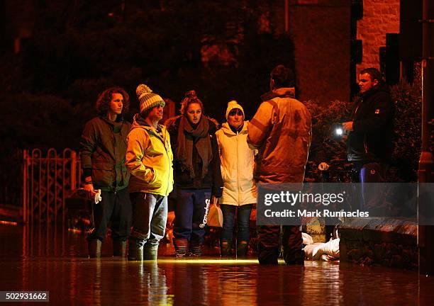 Residents of Kingsmeadows Road only just managing to keep flood water from entering their homes after rain fall from Storm Frank caused the river...