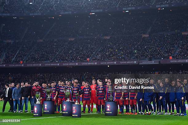 Barcelona players pose with La Liga, UEFA Champions League, Copa del Rey, UEFA Supercup and FIFA Club World Cup trophies prior to the La Liga match...