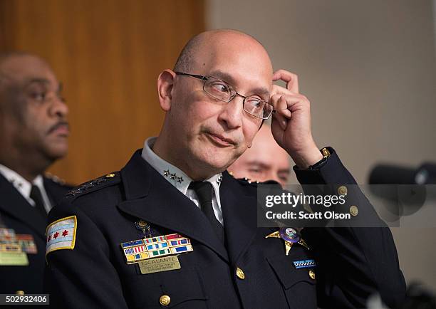 Interim Chicago Police Superintendent John Escalante listens as Chicago Mayor Rahm Emanuel addresses changes in training and procedures that will...