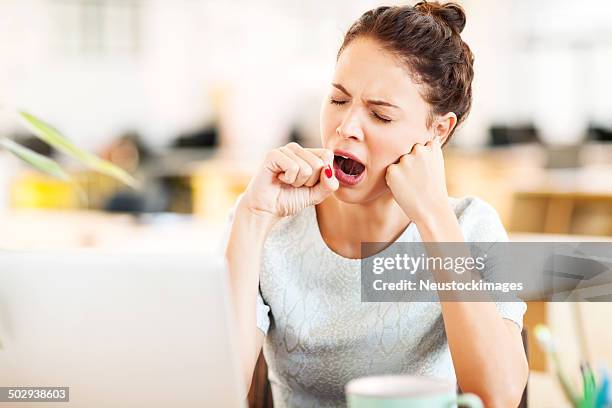 entrepreneur yawning in office - beautiful woman and tired stock pictures, royalty-free photos & images