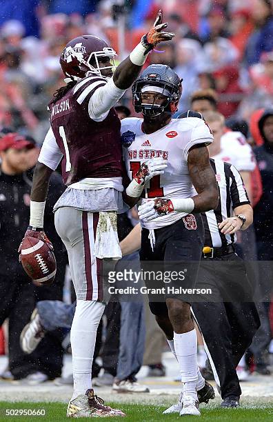 De'Runnya Wilson of the Mississippi State Bulldogs signals for a first down after making a catch against Juston Burris of the North Carolina State...