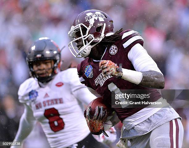 De'Runnya Wilson of the Mississippi State Bulldogs makes a touchdown catch against Dravious Wright of the North Carolina State Wolfpack during the...