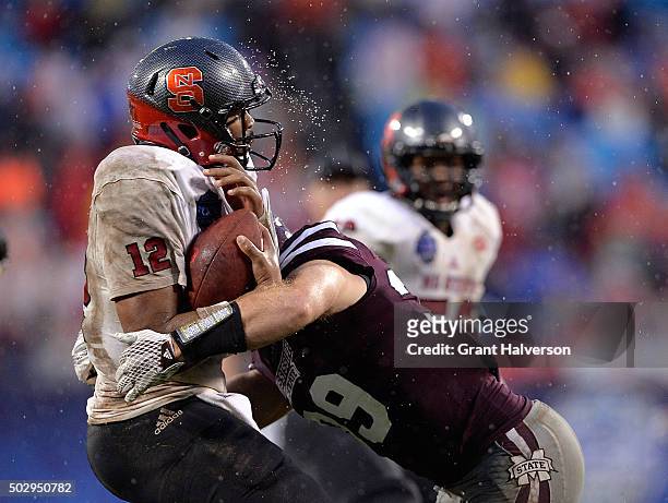 Richie Brown of the Mississippi State Bulldogs sacks Jacoby Brissett of the North Carolina State Wolfpack during the Belk Bowl at Bank of America...