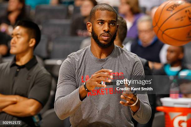 Chris Paul of the Los Angeles Clippers warms up before the game against the Charlotte Hornets at the Time Warner Cable Arena on December 30, 2015 in...