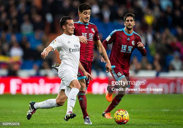Lucas Vazquez of Real Madrid CF competes for the ball with Yuri Berchiche of Real Sociedad during the Real Madrid CF vs Real Sociedad match as part...