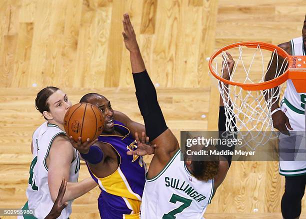 Kobe Bryant of the Los Angeles Lakers takes a shot over Jared Sullinger of the Boston Celtics during the first quarter at TD Garden on December 30,...