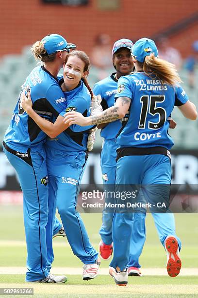 Megan Schutt of the Adelaide Strikers is congratulated by teammates after bowling out Chloe Piparo of the Perth Scorchers during the Women's Big Bash...