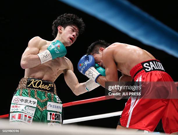 Champion Kosei Tanaka of Japan lands his left upper on Vic Saludar of Philippines during the WBO minimum weight title match in Nagoya in Aichi...