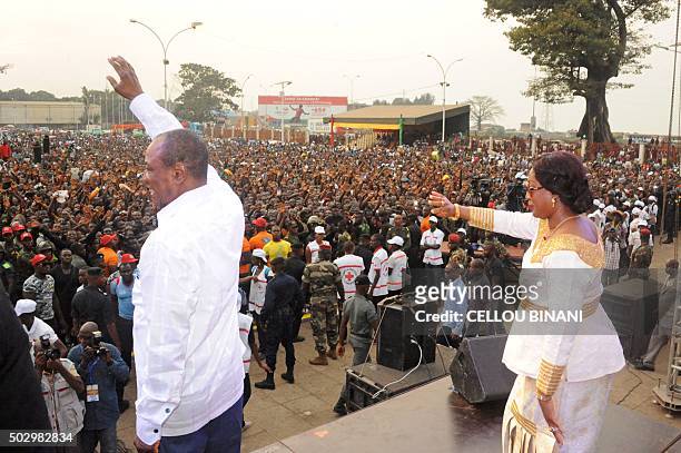 Guinea's president Alpha Konde and Guinea's First Lady Djene Kaba Conde waves to the public at the "Bye bye, Au revoir Ebola" concert on December 30,...