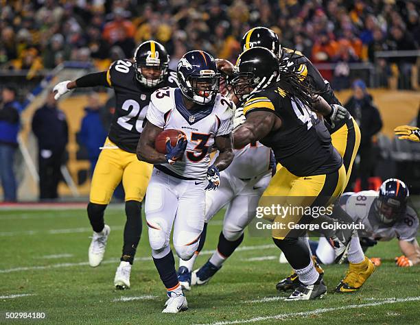 Running back Ronnie Hillman of the Denver Broncos runs with the football as he is pursued by safety Will Allen and defensive lineman Steve McLendon...