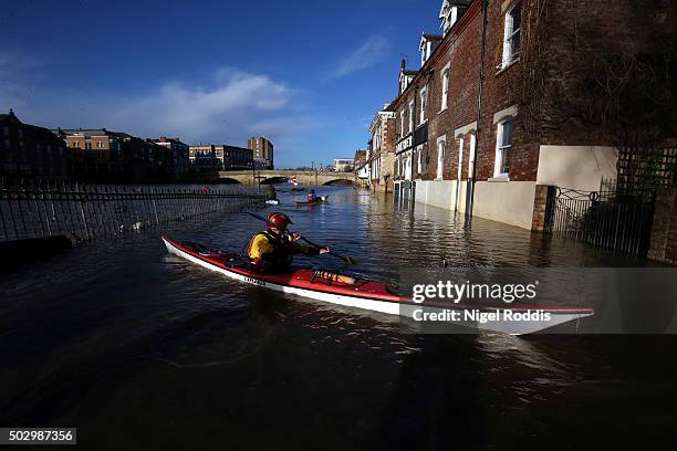 Canoeists check out buildings in flooded York on December 31, 2015 in York, England. The Met Office have issued yellow warnings after Storm Frank hit...