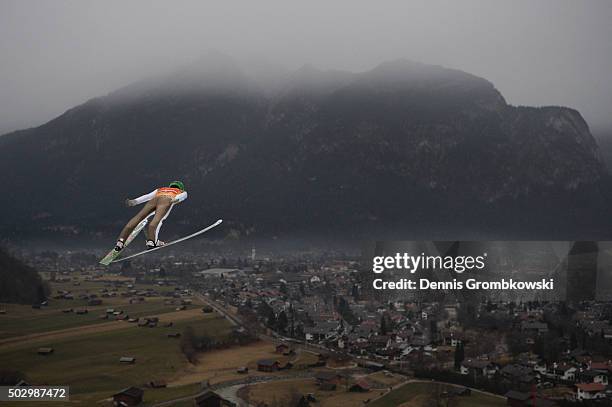 Peter Prevc of Slovenia soars throught the air during his qualification jump on Day 1 of the 64th Four Hills Tournament ski jumping event on December...