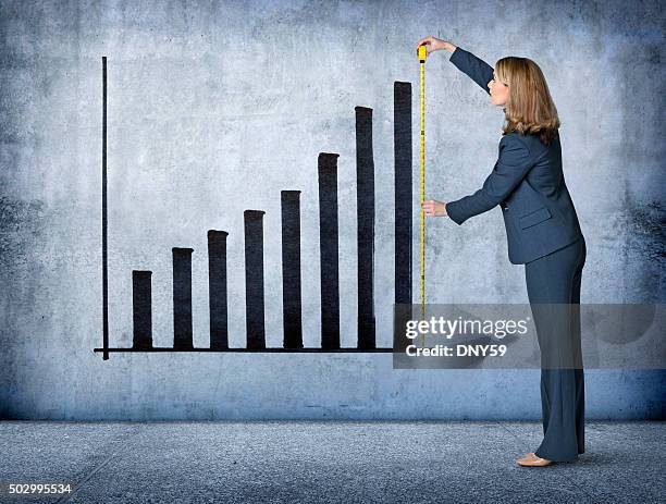 businesswoman measures growth with tape measure - measuring stock pictures, royalty-free photos & images