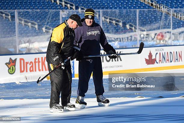 Head Coach Bill Belichick of the New England Patriots and head coach Claude Julien of the Boston Bruins skate prior to team practices prior to the...