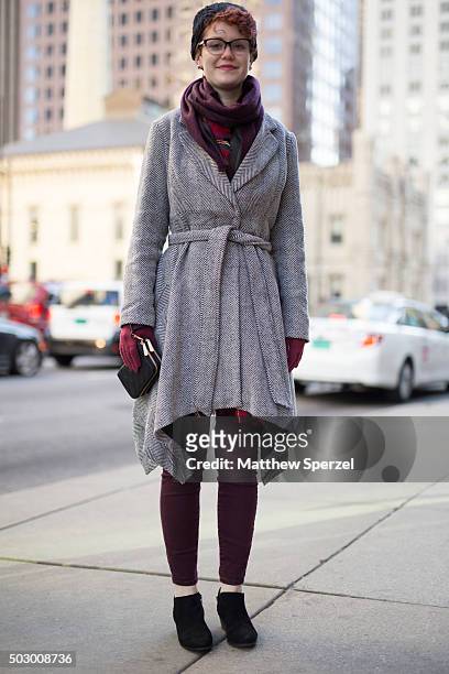 Maggie Shorb is seen on Michigan Avenue wearing a dark blue Columbia hat, locally-made maroon alpaca wool scarf, grey Ryu coat, black Charming...